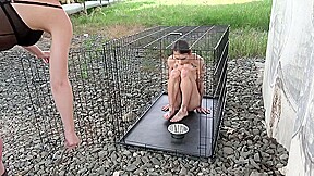 Exposed in the public pillory cage by Femdom Austria