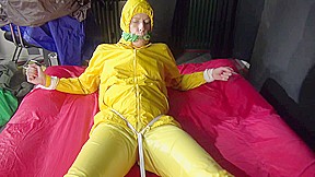 Watching Sexy Pia Being Tied And Gagged With Ropes On A Bed And A Clothgag Wearing Sexy Yellow Shiny Nylon Rainwear (Video)
