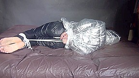 Watching Sexy Sandra Being Tied And Gagged On A Bed With Ropes And A Ballgag Wearing A Supersexy Shiny Black Nylon Pants And A Silver Down Jacket (Video)