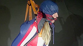 Watching Sexy Sandra Wearing A Sexy Oldschool Downbib And A Down Jacket Being Suspended, Tied, Gagged And Hooded With Ropes And A Ballgag (Video)