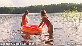 Margo Von Teese and Simona splash each other in their bikinis in a lake before eating each other out on the beach. – Margo Von Teese and Simona – NaughtyMag
