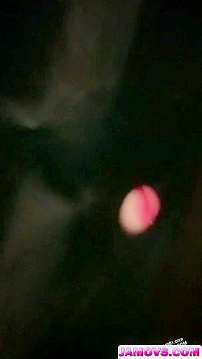 A covert camera captures a black-clad Asian whore.