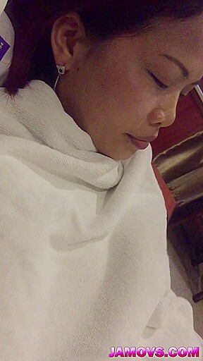 A young Chinese woman and her boyfriend watch