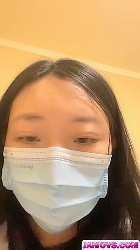 An Asian woman is seen urinating on in a public washroom